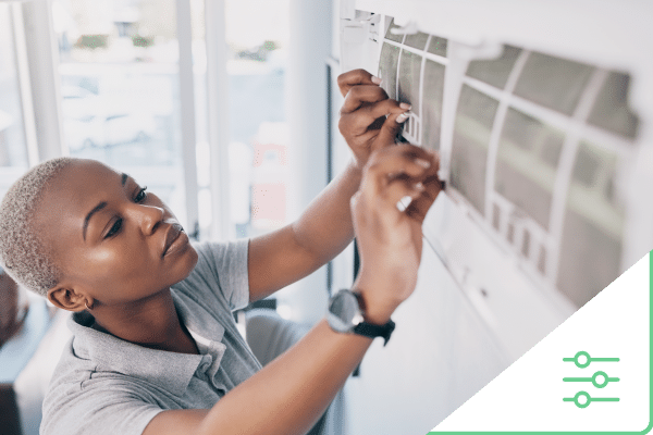 Female construction worker changing air filter