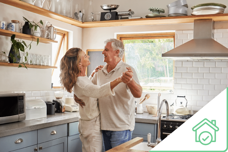 Older couple dancing in kitchen