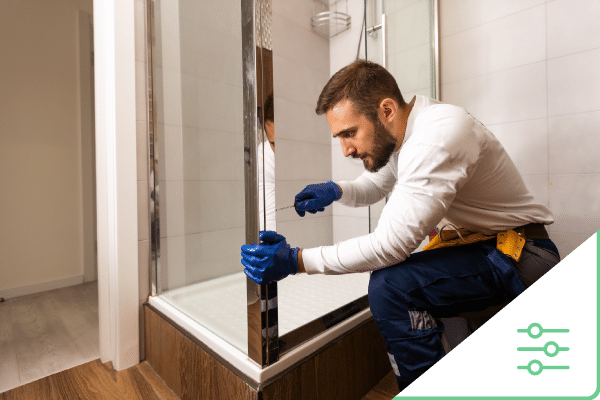 Construction worker working on shower door