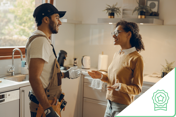 Diverse construction worker and client talking in kitchen