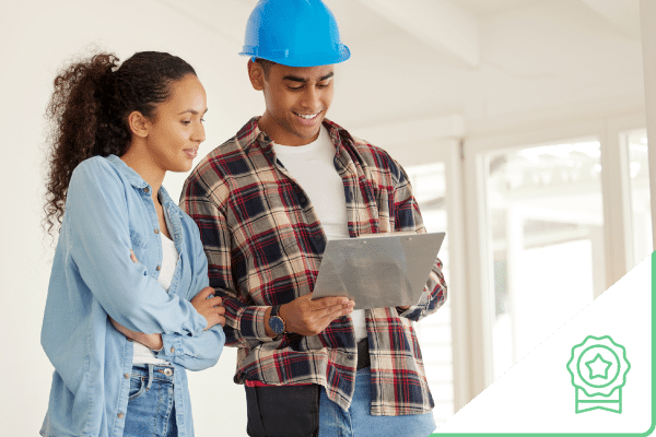 Woman talking to construction worker looking at tablet