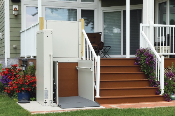 Residential mobility lift next to outdoor deck stairwell