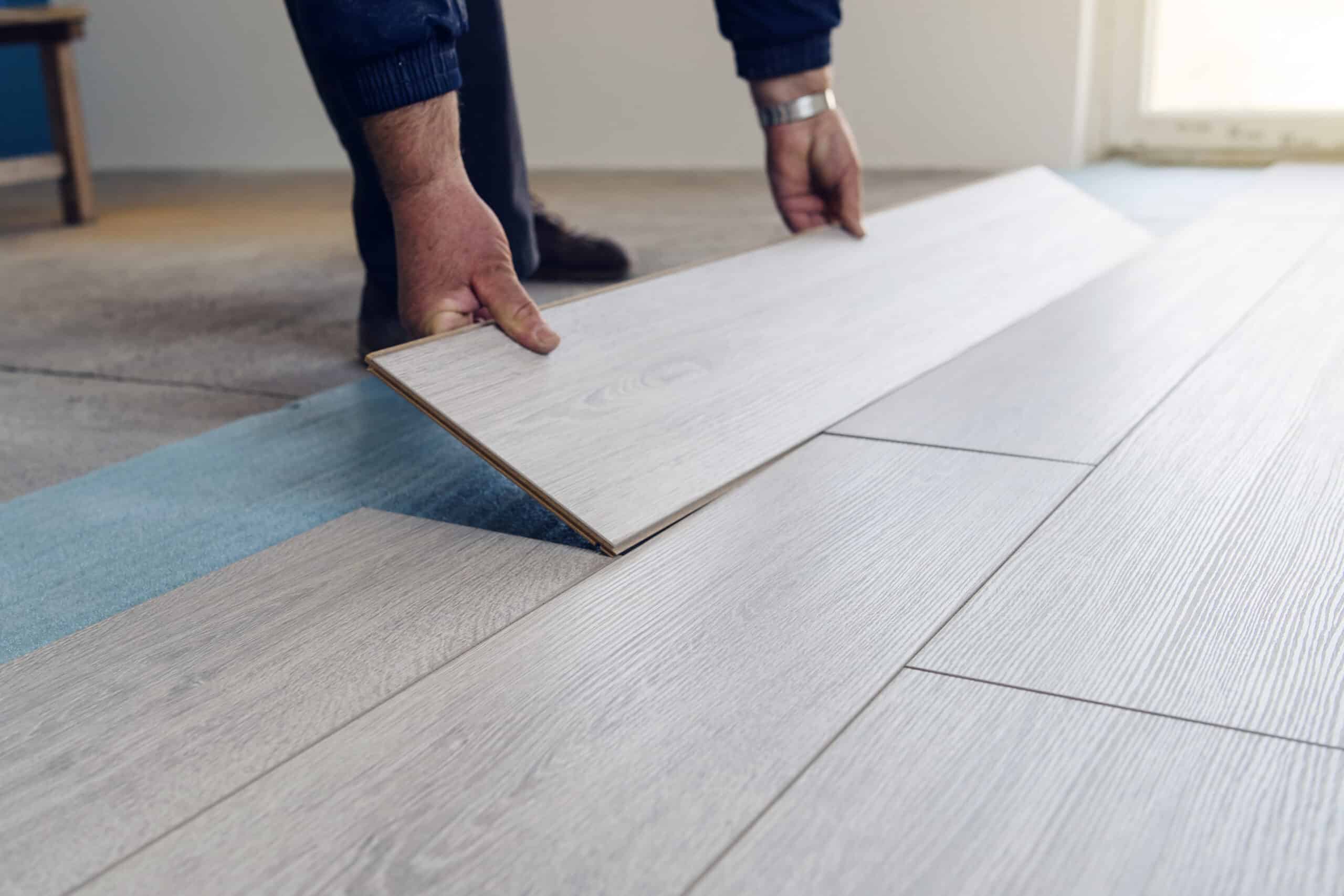 Diverse construction worker installing LVP flooring