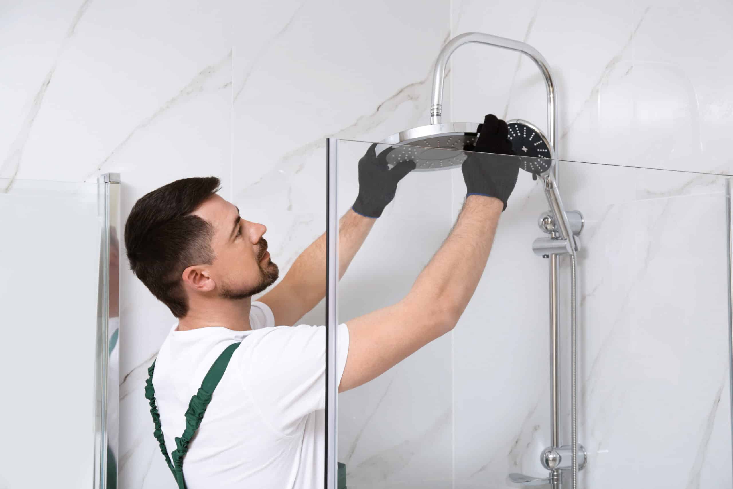 Construction worker installing shower head