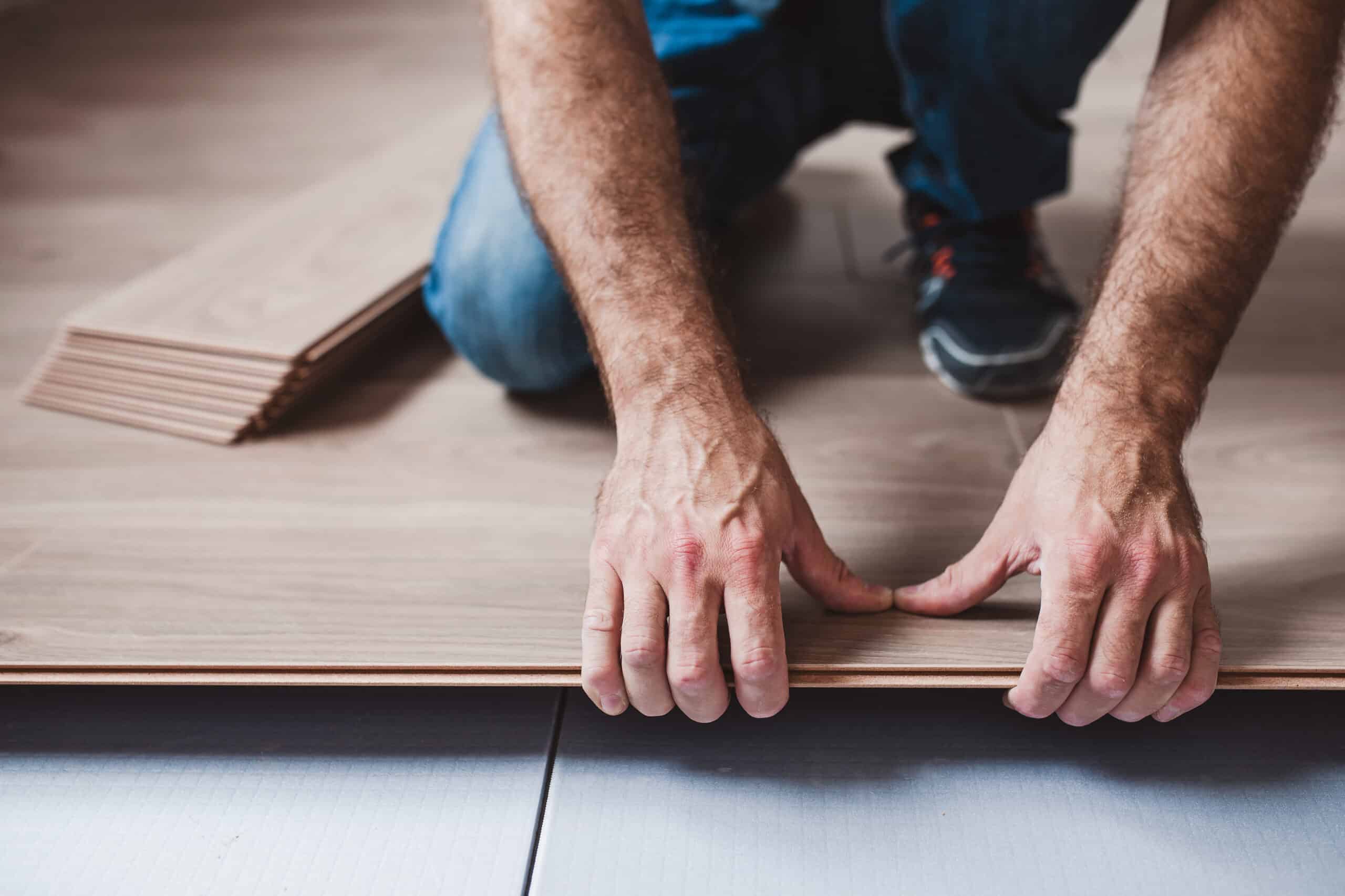 Construction worker installing LVP flooring