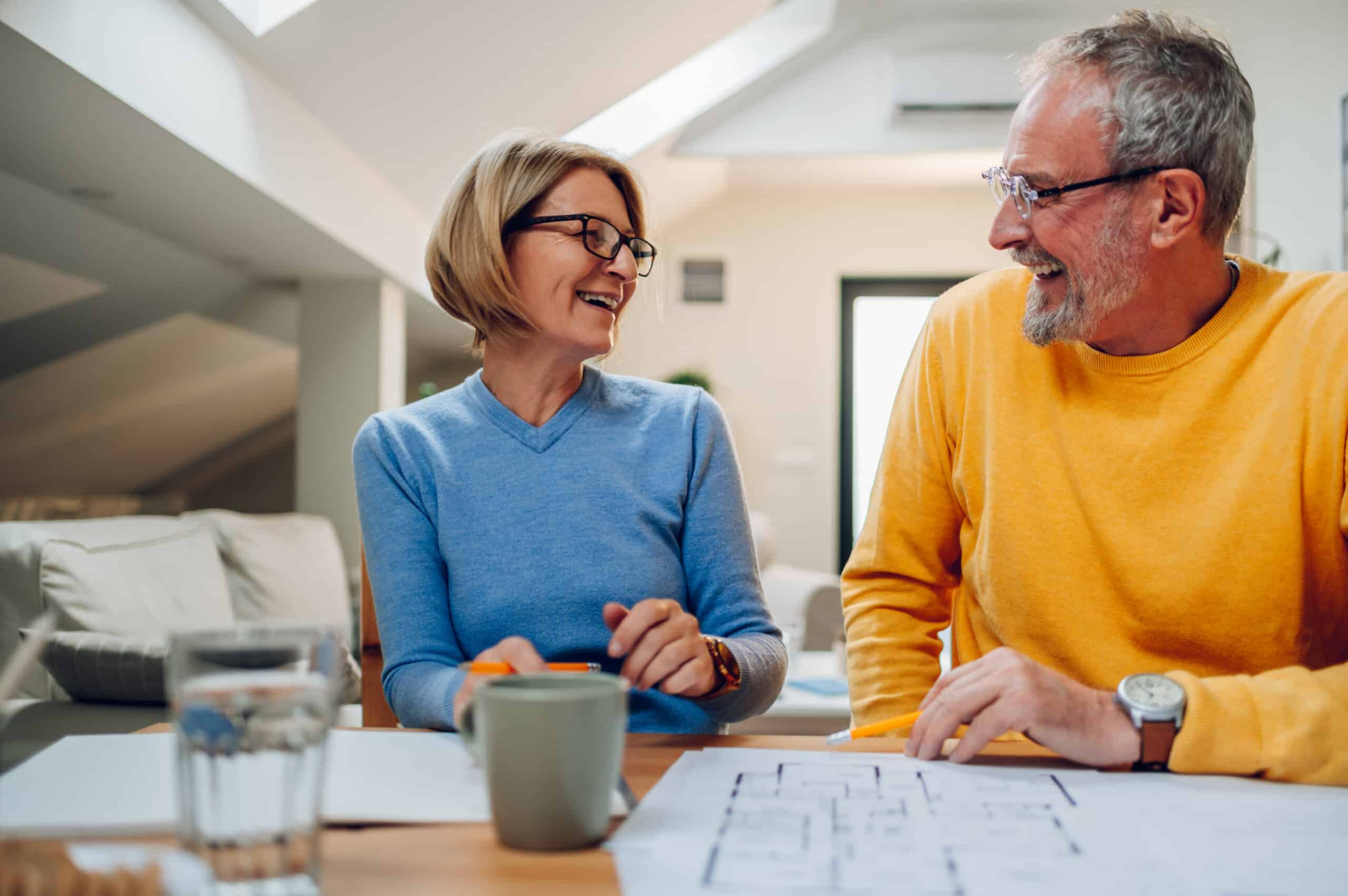 Middle aged couple looking at house remodeling plans